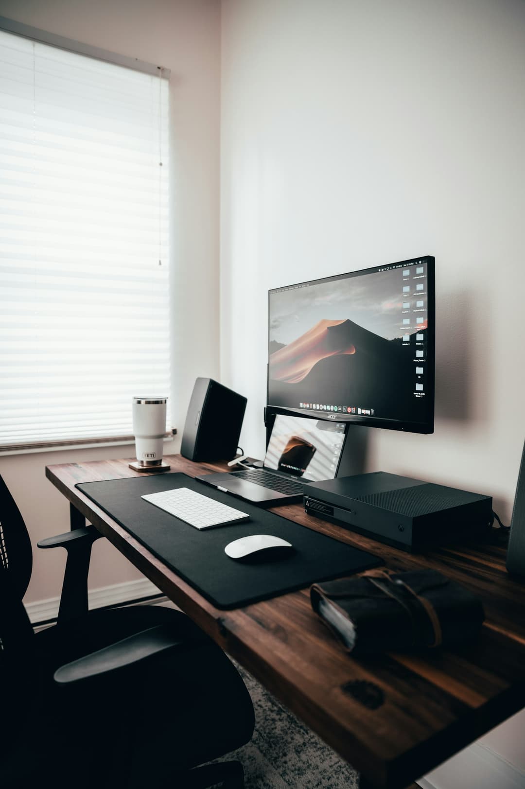 Desk setup with monitor displaying analytics dashboard